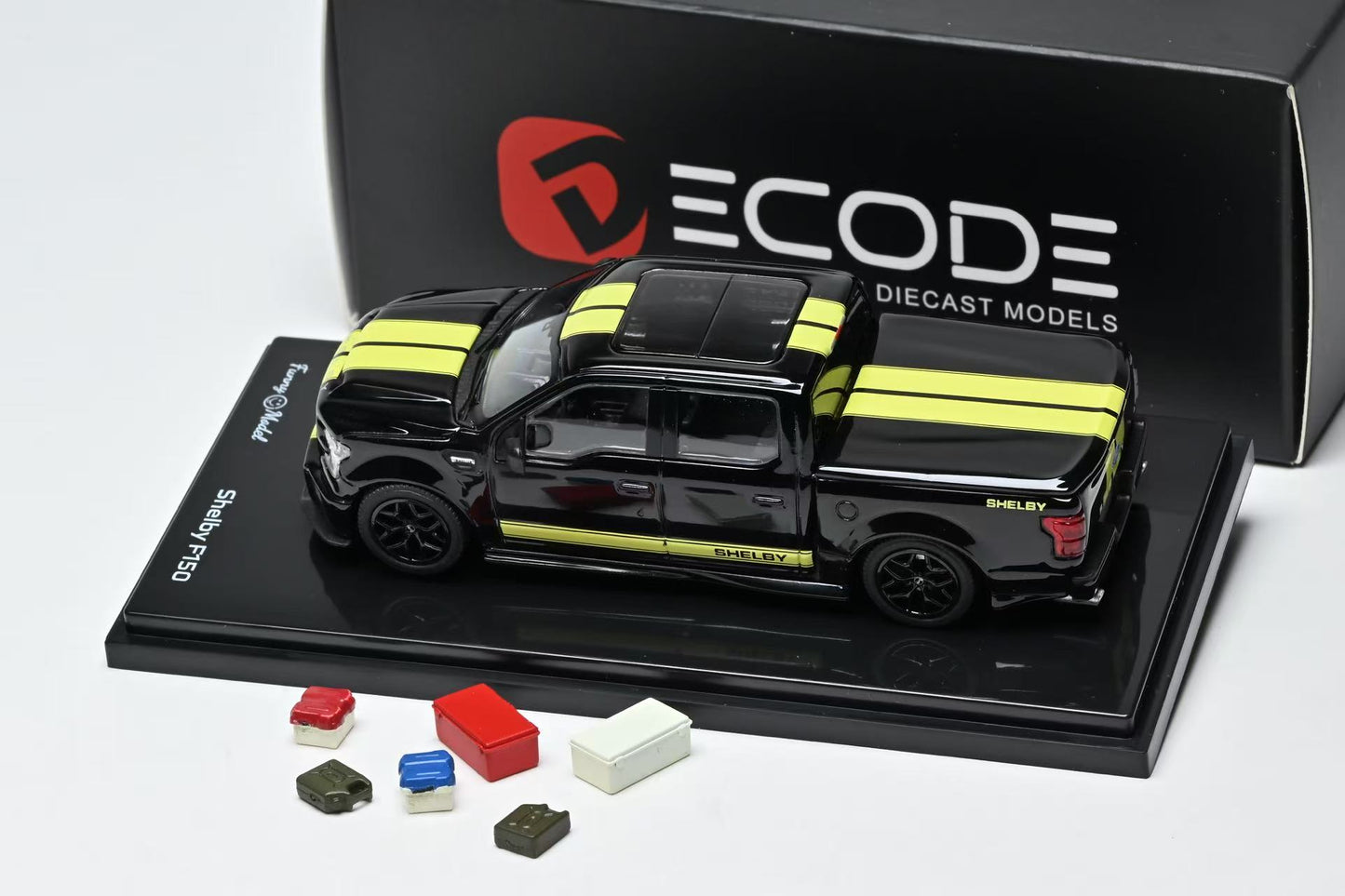 Black and yellow stripe Ford Shelby F150 model truck on a display stand and tools with a white background
