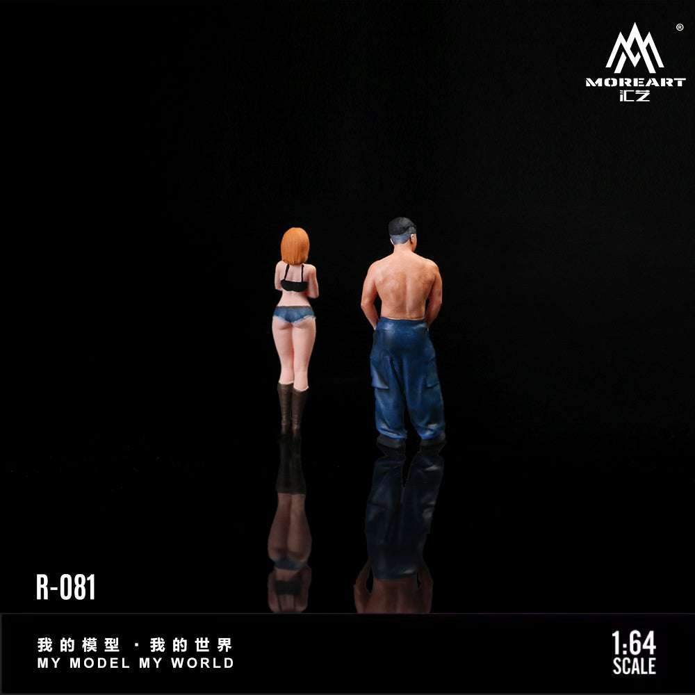 Two miniature figures of a man and a woman standing back-to-back on a reflective surface with 'MOREART' branding.