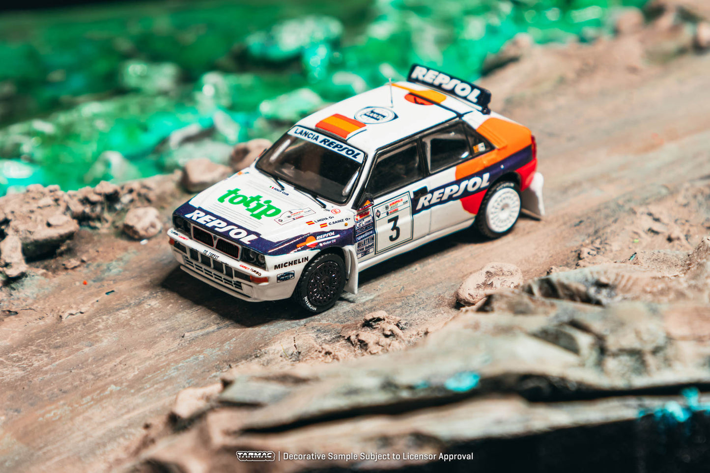 Model car on a rocky surface with a blurred green background
