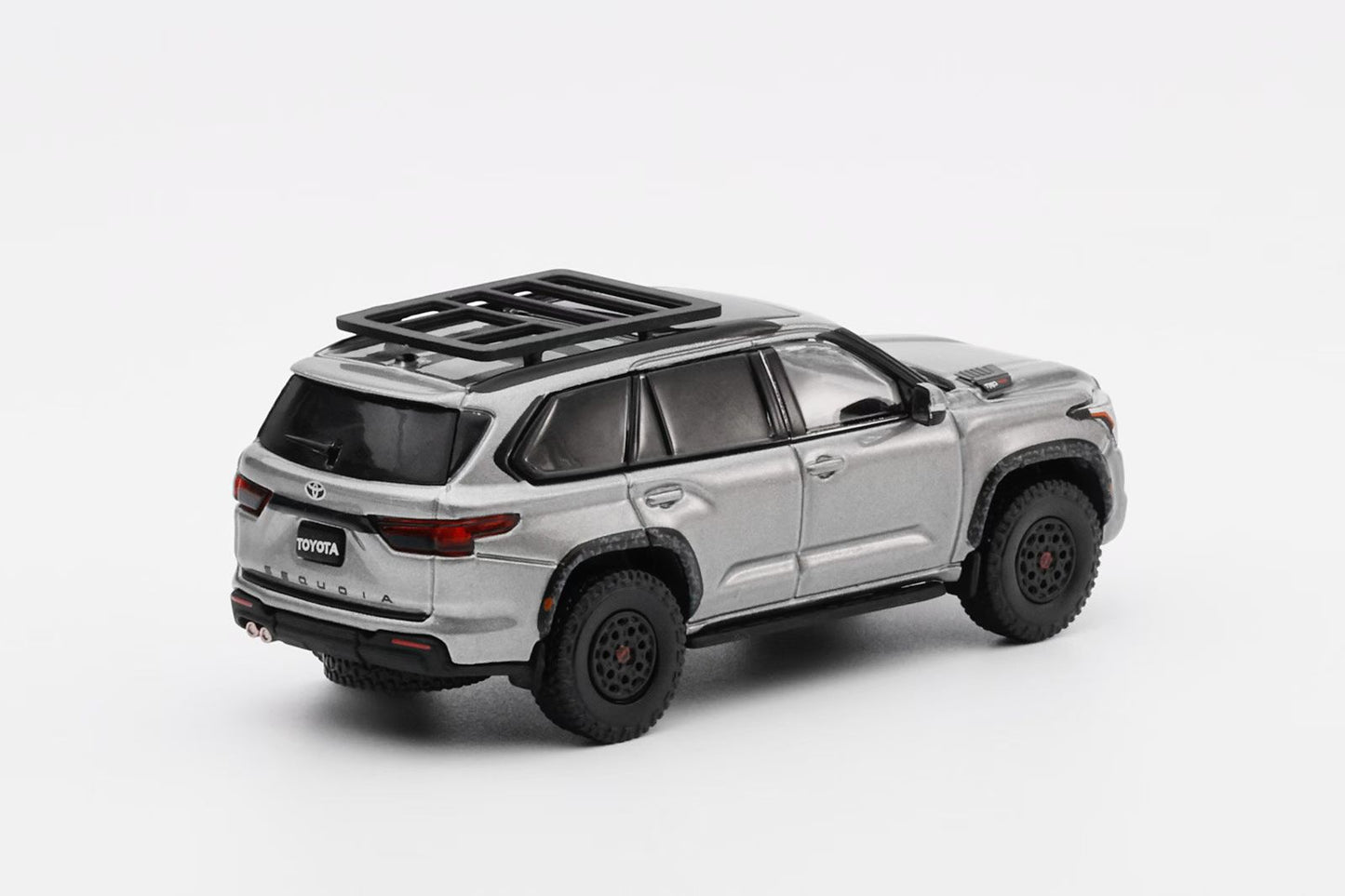 Silver SUV with roof rack on a white background