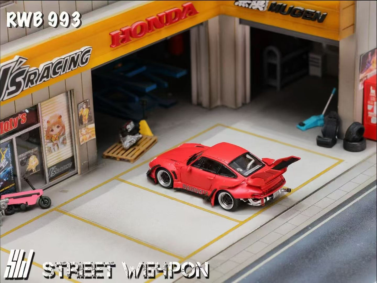 Model car in a garage with 'Honda' and 'HKS Racing' branding.