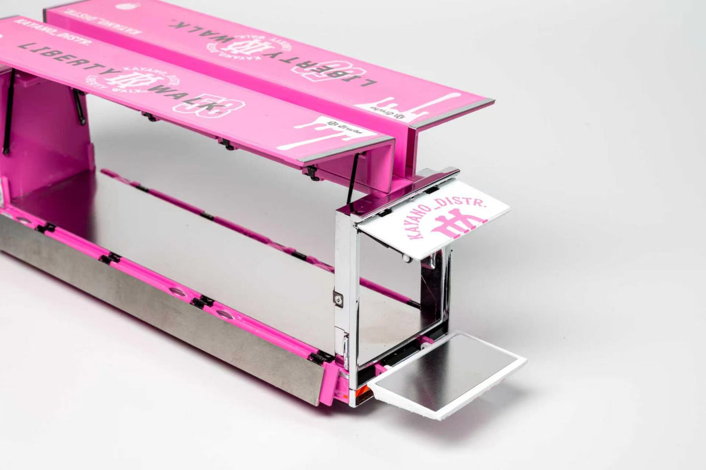 A pink and silver cardboard food truck kit with printed graphics, shown open on a light gray background.