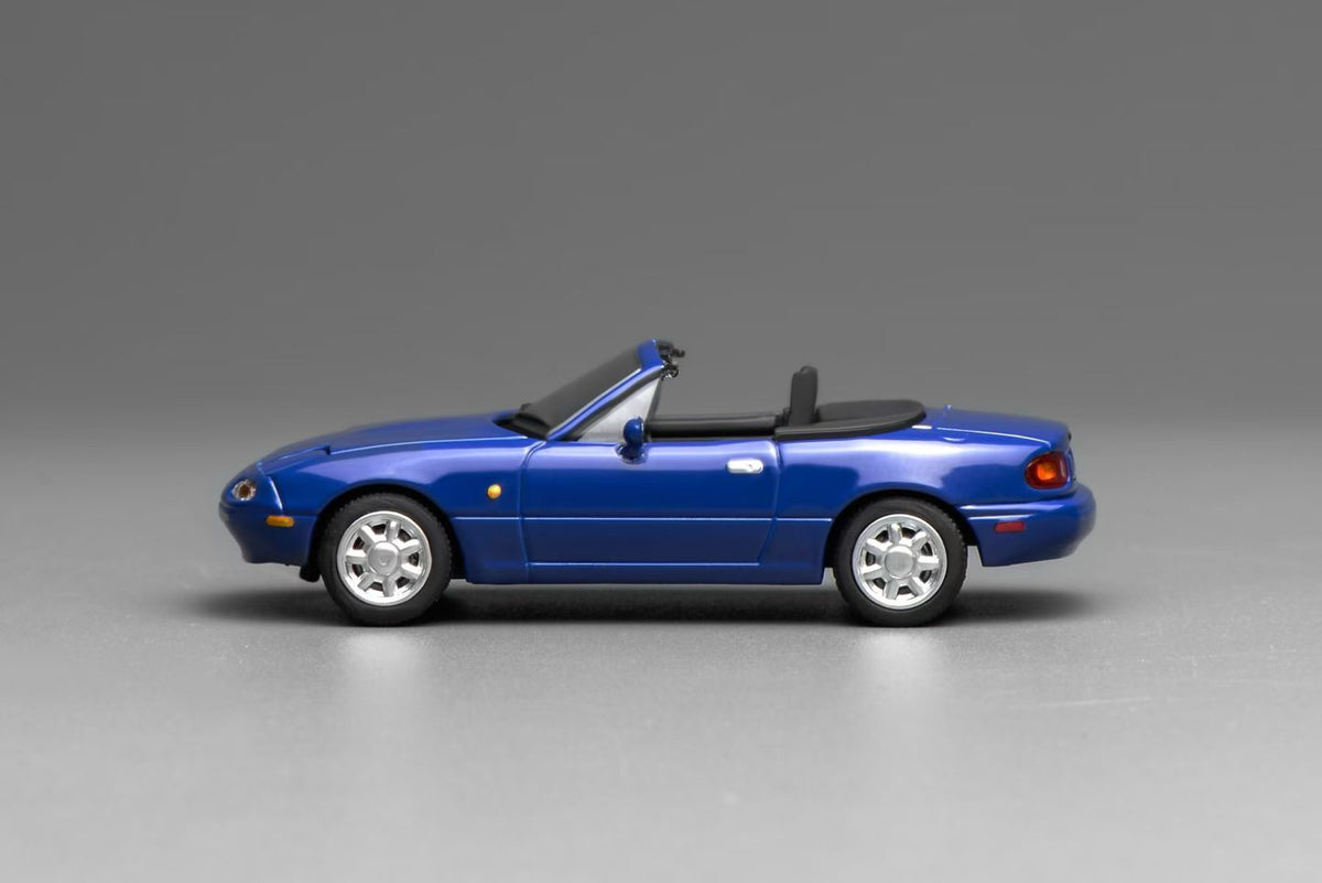 Blue convertible car on a gray background