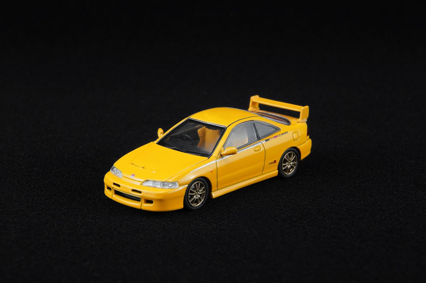 Yellow model car on a black background