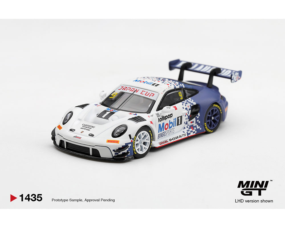 MINI GT 1:64 Porsche 911 GT3 R #9 Mobil 1 Japan Cup race car diecast model MGT01435-BL, front three-quarter view featuring white and blue pixel racing livery, Mobil 1 sponsorship, white front wheels, blue rear wheels, and large rear wing.