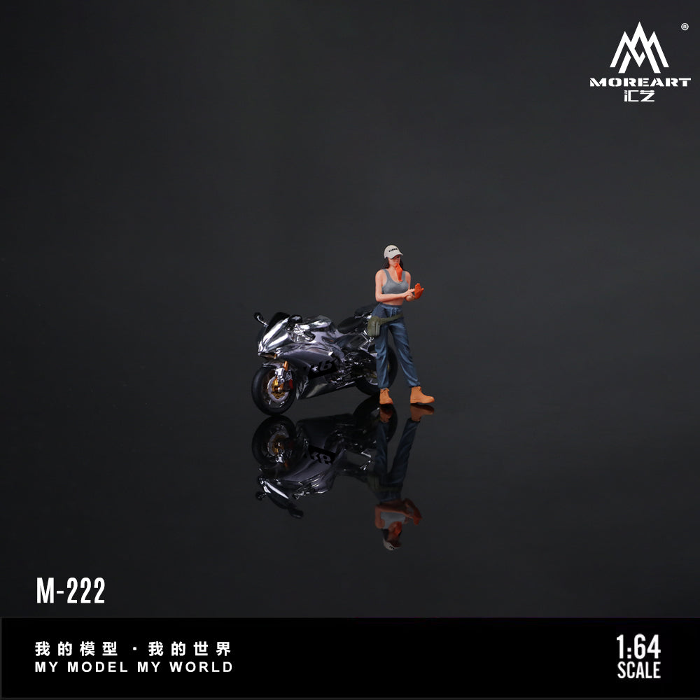 Miniature figure of a person with a motorcycle on a reflective surface with 'MOREART CZ' branding.