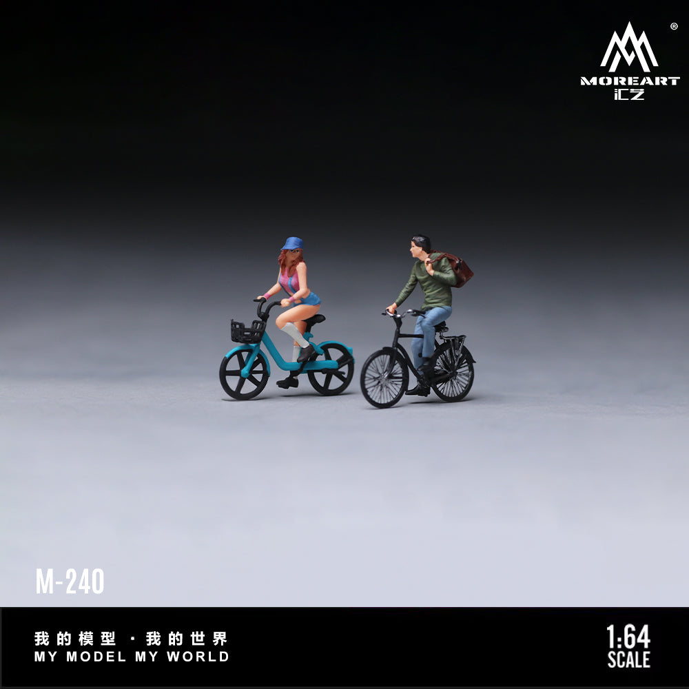 MoreArt 1:64 Cycling Couple Figure Set M-240 shown in a studio side view featuring two miniature cyclist figures riding detailed bicycles, ideal for 1:64 scale diecast model car dioramas, city street scenes and miniature displays.