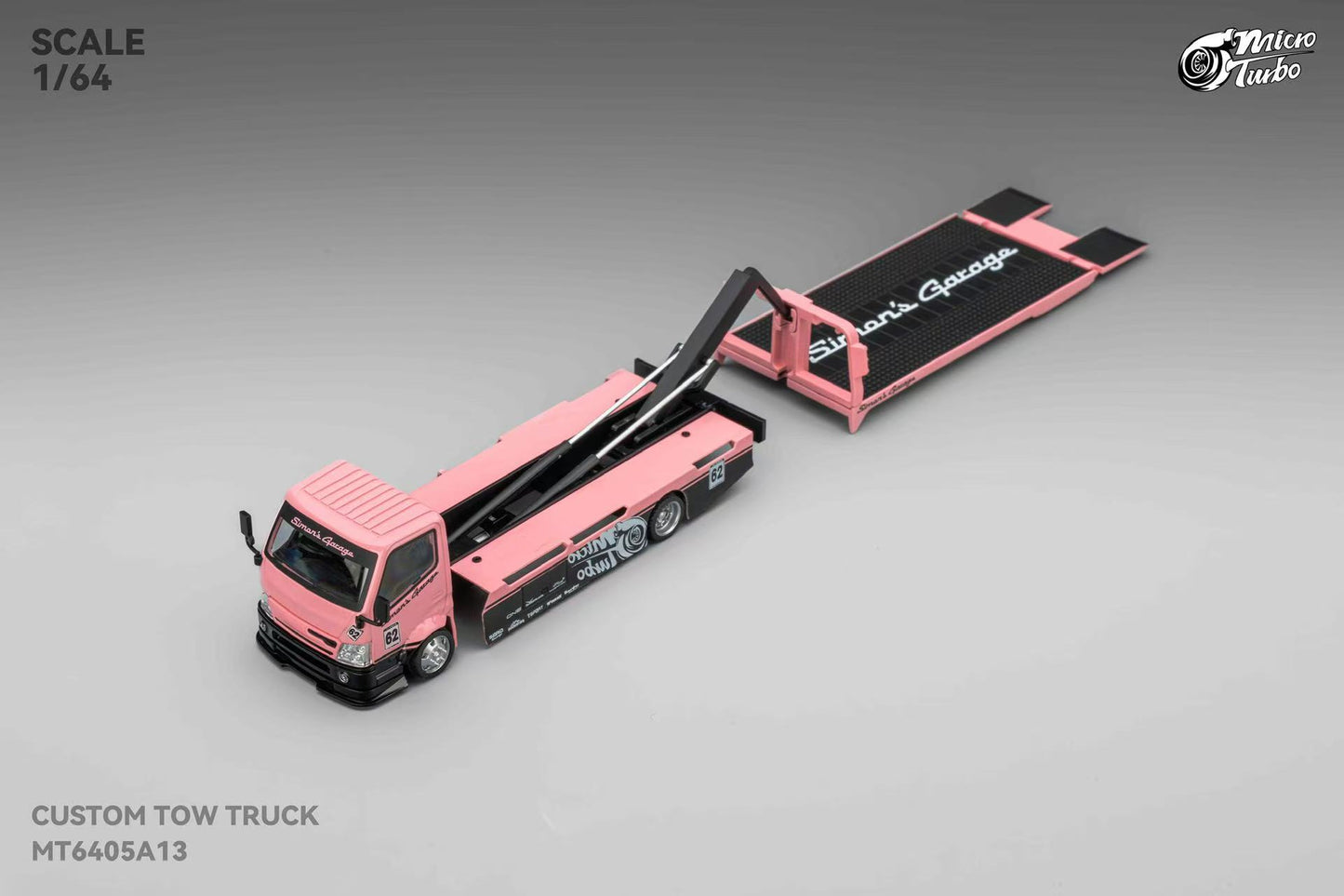Model of a pink tow truck with an open cargo area on a gray background