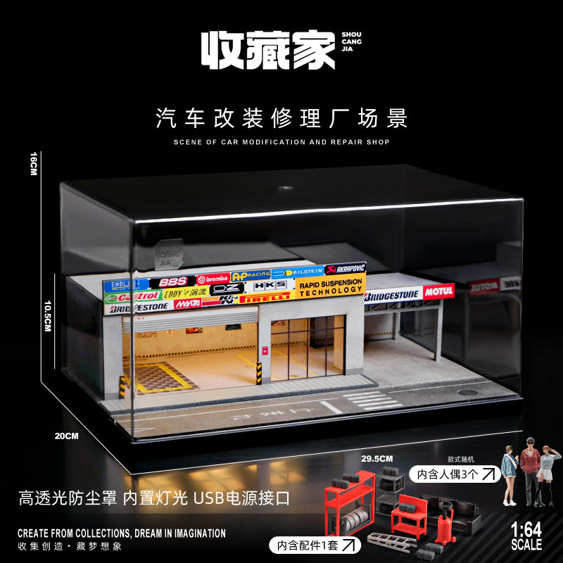 A 1:64 scale miniature car workshop scene display box with transparent acrylic sides and a black interior base, shown on a black background with Chinese text overlays and small scale/model references.