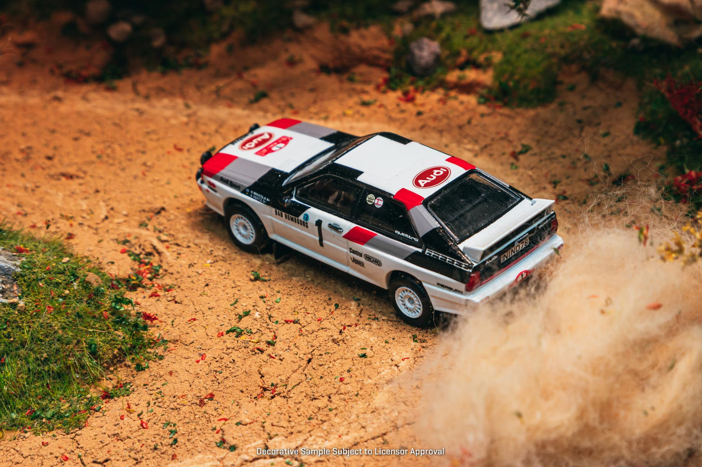 Model car on a dirt track with a desert landscape
