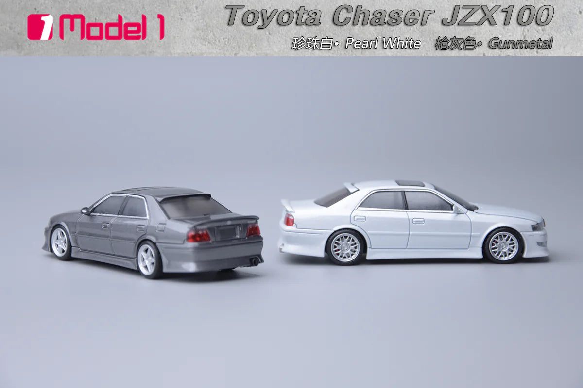Two toy model cars, one gray and one white, on a light gray background with 'Toyota Chaser JZX100' text.