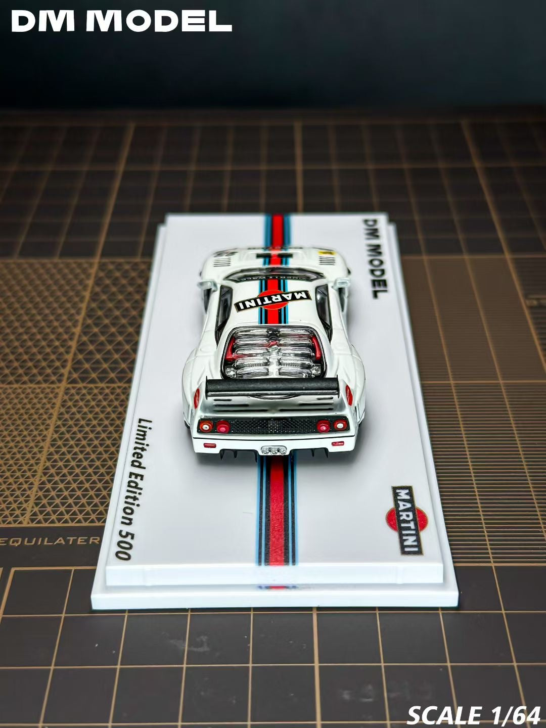 Model car on a display card with 'DM Model' branding on a grid background