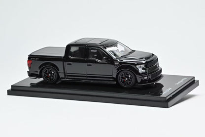Black Ford Shelby F150 model truck on a display stand with a white background
