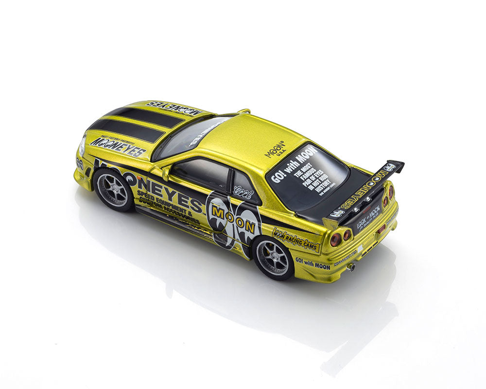 A yellow die-cast model car with black racing stripes and various sponsor decals, photographed on a clean white background.