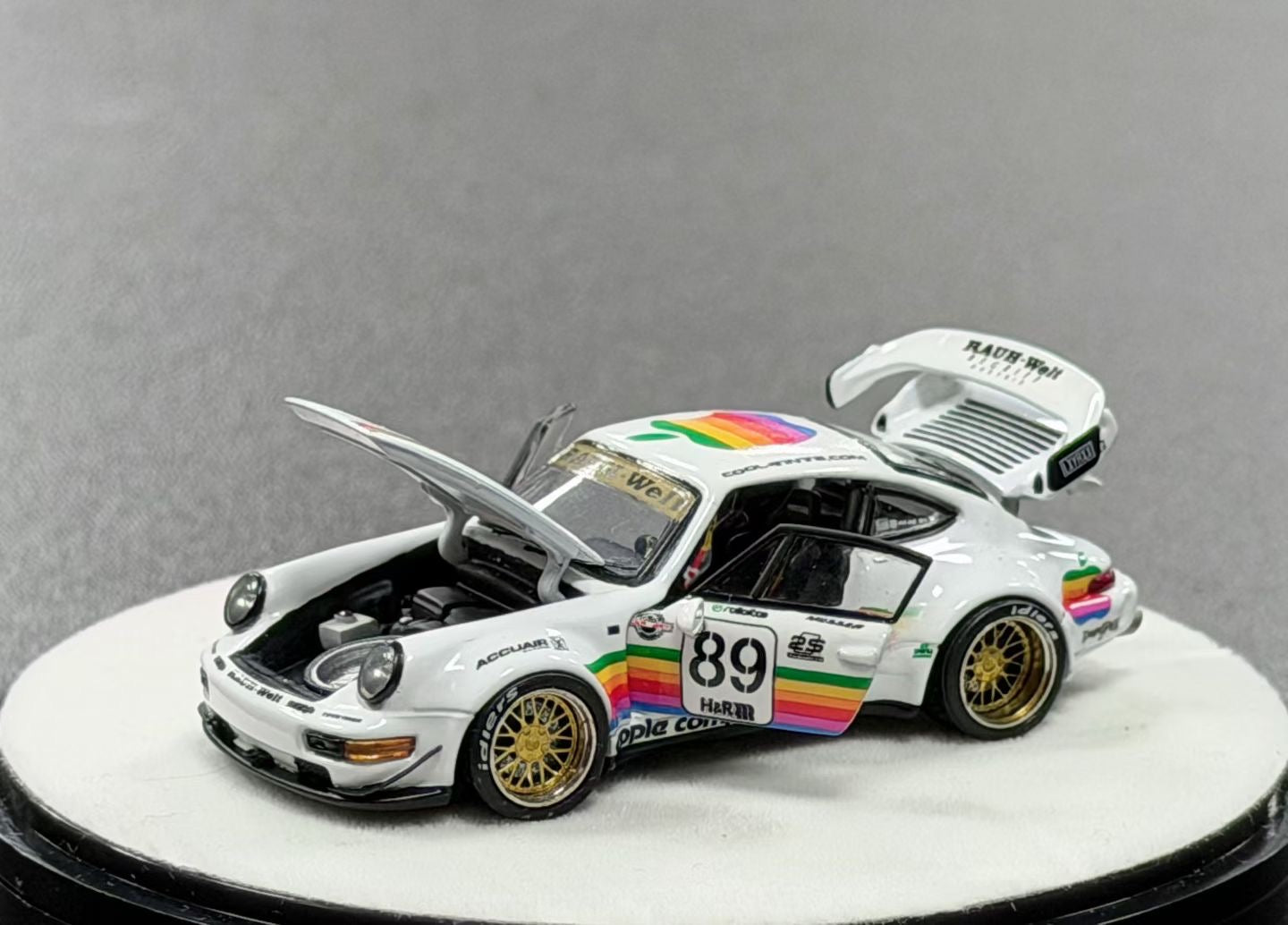 Model car with rainbow livery on a gray background
