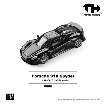 Model car of a black Porsche 918 Spyder at 1:64 scale. Positioned on a white surface with "Trends Hobby" logo and product details in the background.