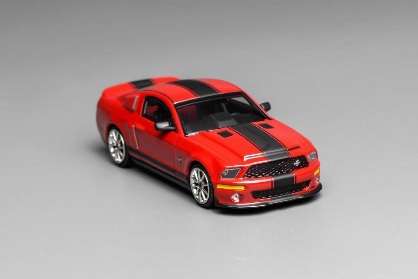 Red and black model car on a gray background