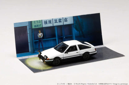 Model car in front of a store with a person in the background