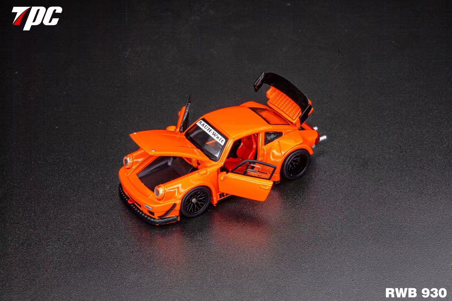 Orange model car with open doors on a dark background