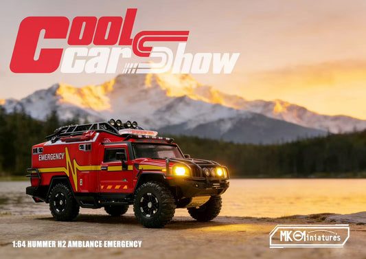 MK Miniatures Cool Car Show Series 1:64 Hummer H2 Ambulance Emergency diecast model featuring a rugged red rescue vehicle with emergency graphics, off-road tires, roof-mounted equipment rack, LED light bar, auxiliary spotlights, detailed expedition styling, and illuminated headlights displayed against a scenic mountain sunset backdrop