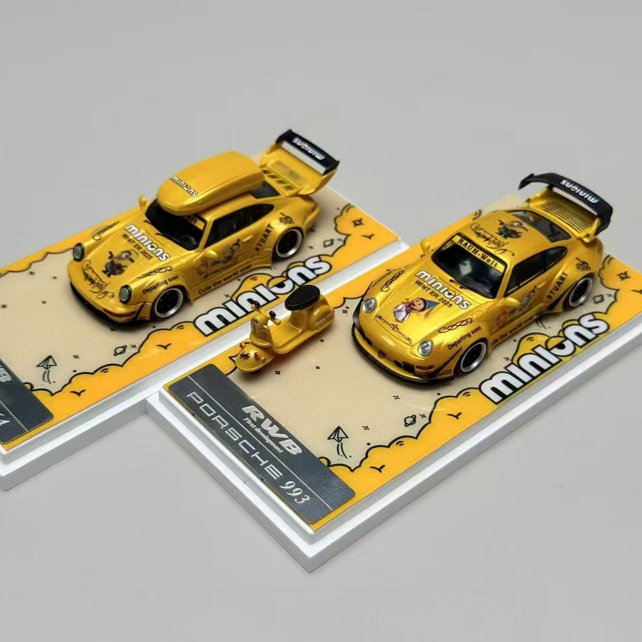 Two yellow model cars on display stands with 'minis' branding.