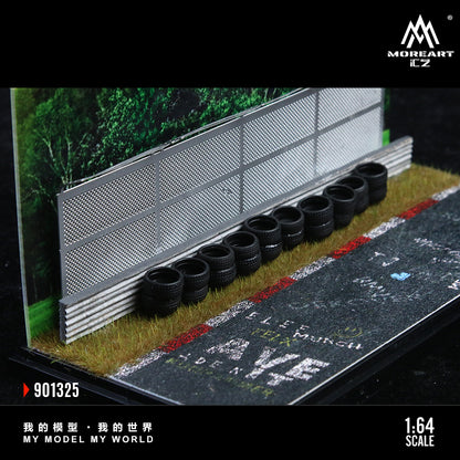 Model racing track with tires and barriers, featuring MoreArt branding.