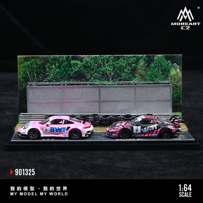 Two model cars on a display stand with a scenic background, featuring the brand 'MoreArt'.