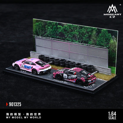Model cars on a display stand with tires and a track background, featuring the brand 'MoreArt'.