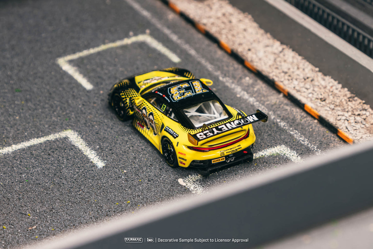Yellow and black model car on a miniature race track