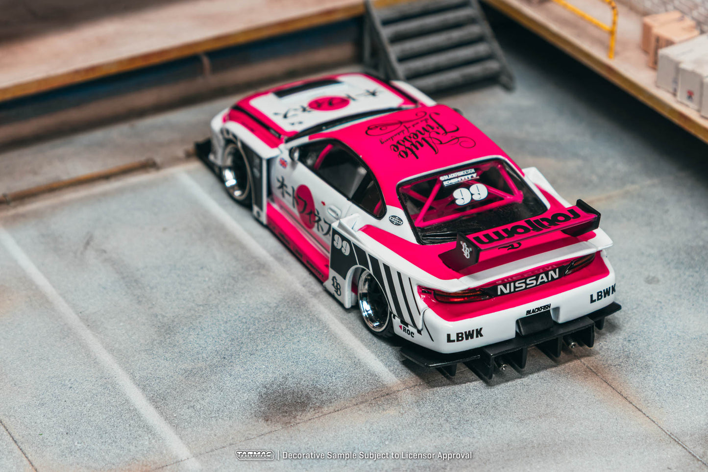 Model car with pink and white design on a concrete surface