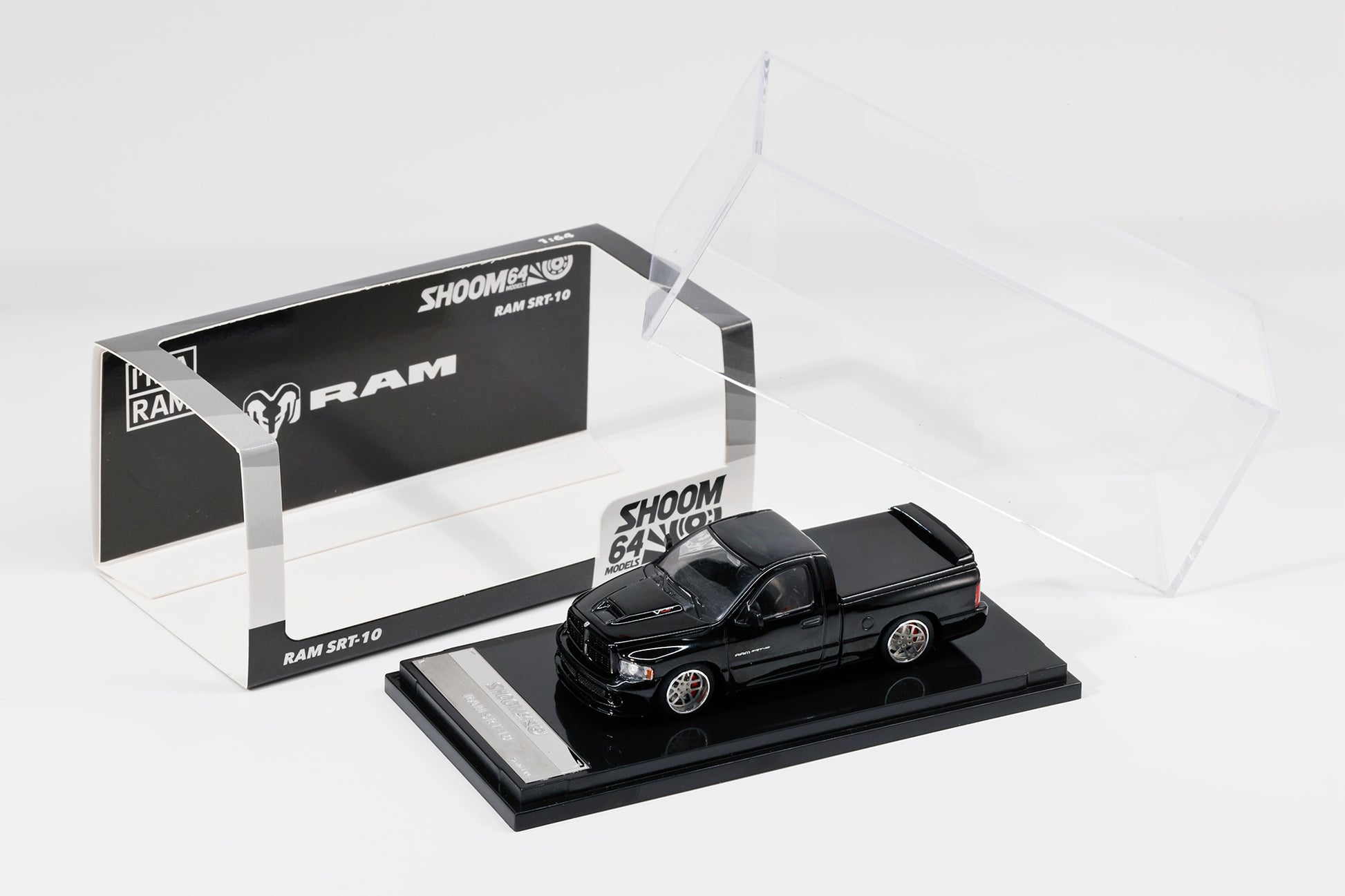 Black model truck on a display stand with 'Shoom' branding