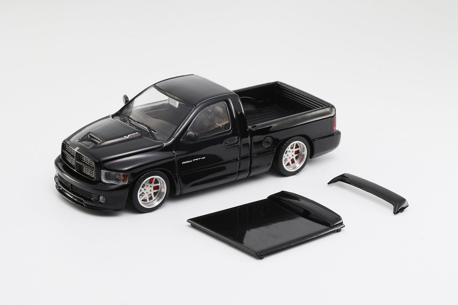 Black model truck with accessories on a white background