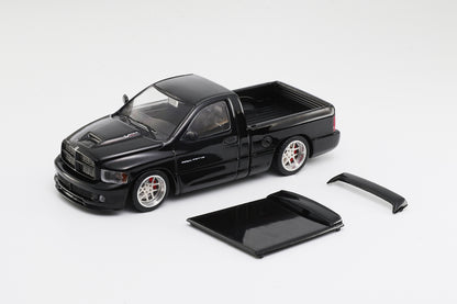 Black model truck with accessories on a white background