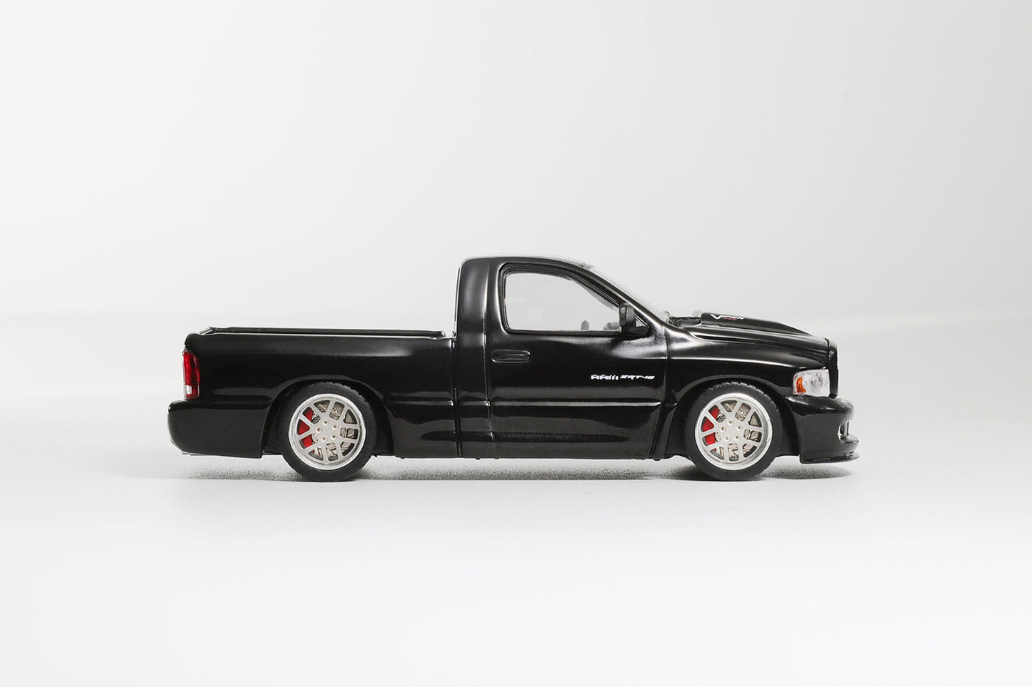 Black pickup truck model on a white background