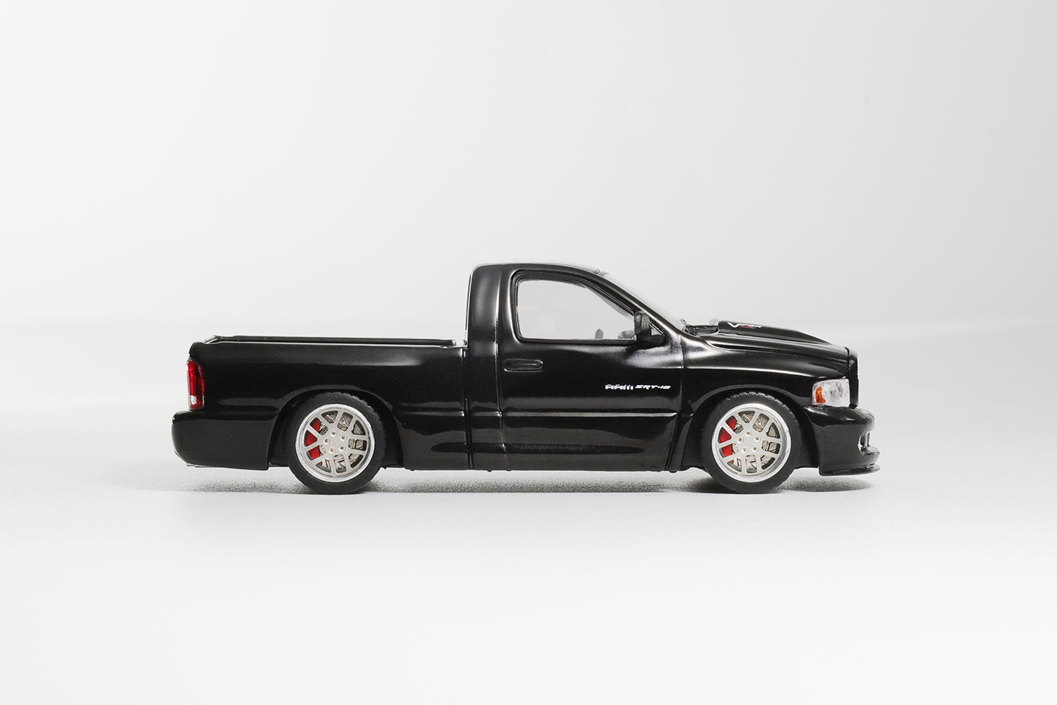 Black pickup truck model on a white background
