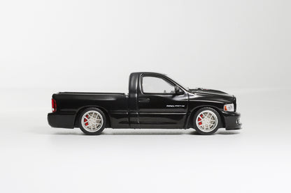 Black pickup truck model on a white background
