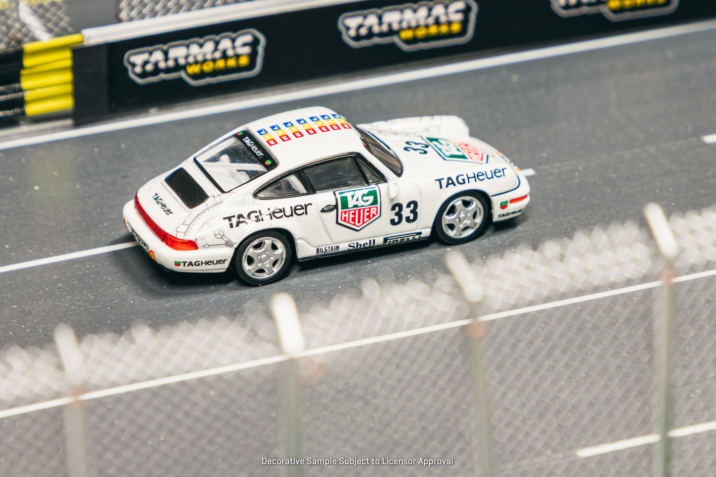 Model car on a track with Tarmac Works branding in the background