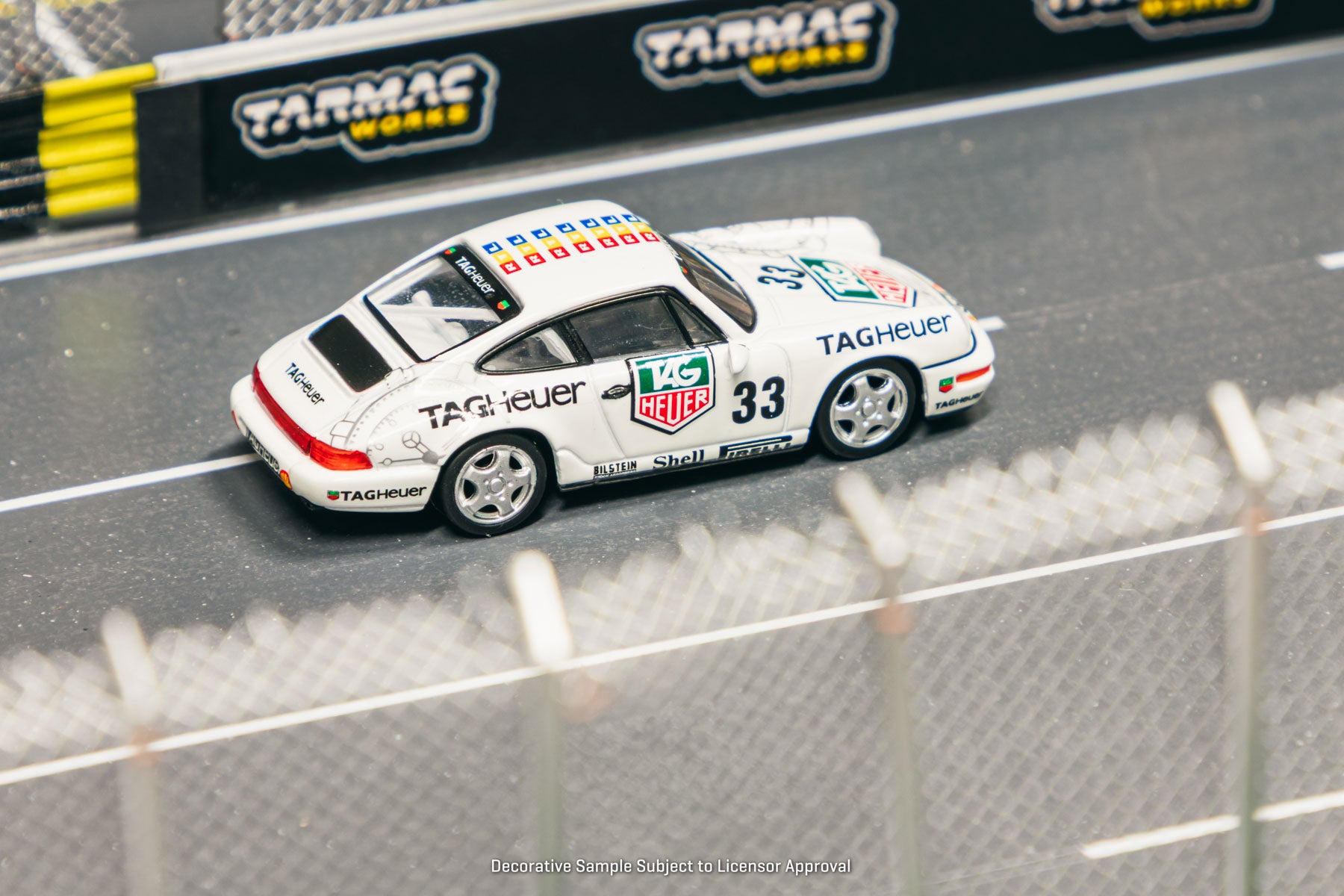Model car on a track with Tarmac Works branding in the background