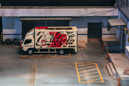 Truck with Coca-Cola branding parked in a warehouse setting