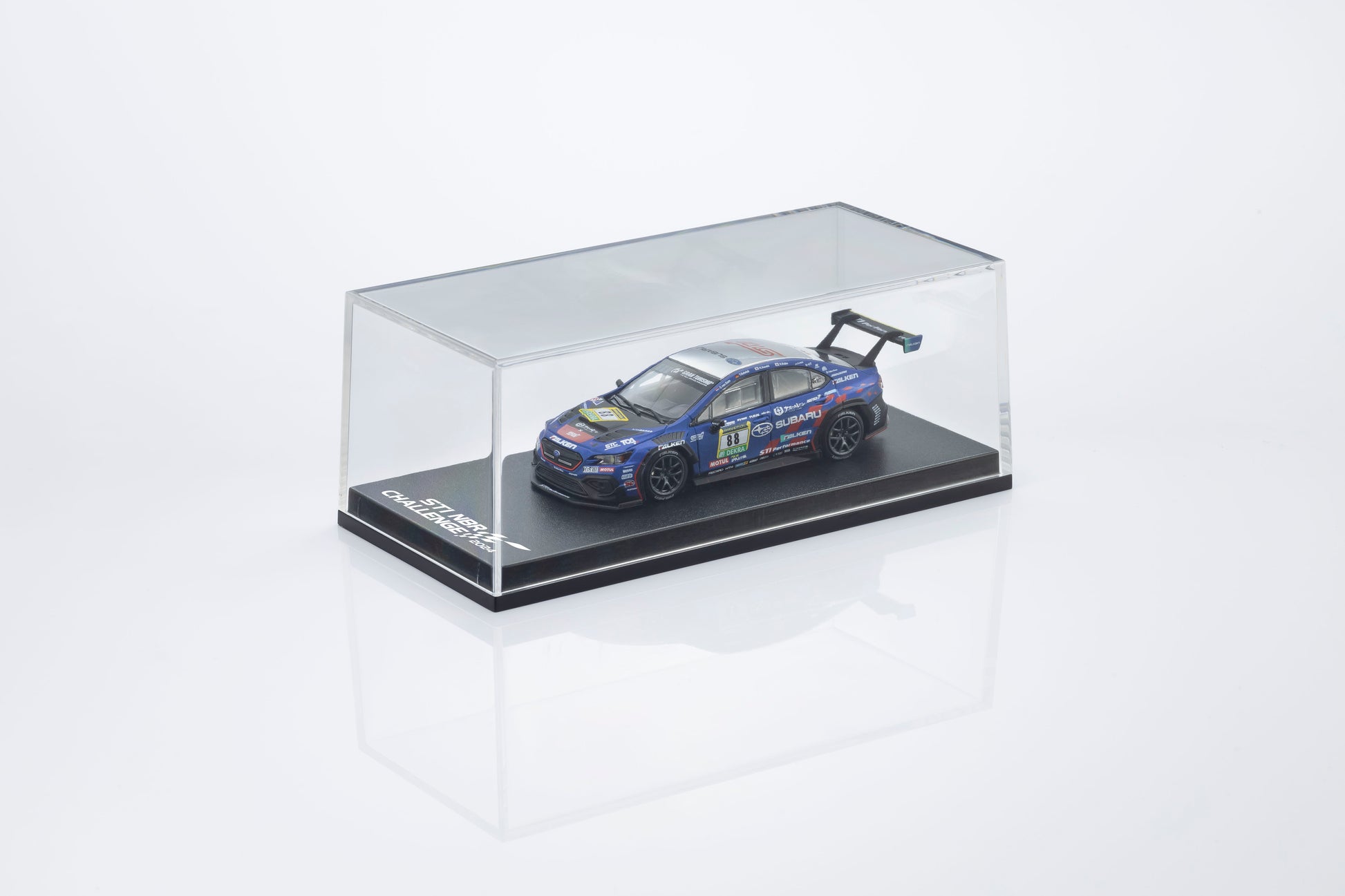Model car in a clear display case on a white background