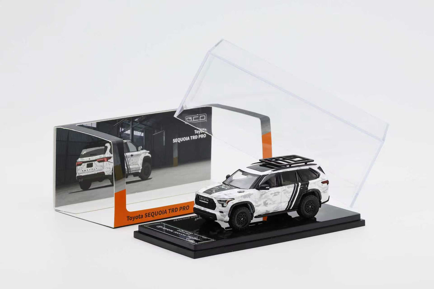 Model car of a SUV in a transparent display case on a white background