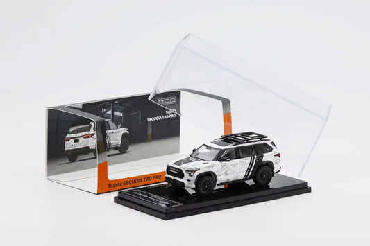 Model car of a SUV in a transparent display case on a white background