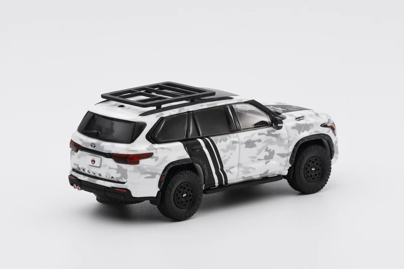 Model SUV with camouflage pattern on a white background