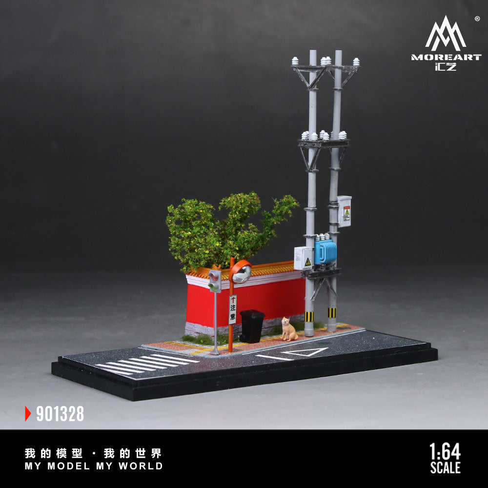 Model street scene with a building, tree, and utility pole on a dark background