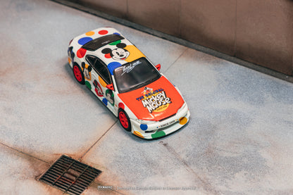 Colorful model car with Mickey Mouse design on a concrete surface