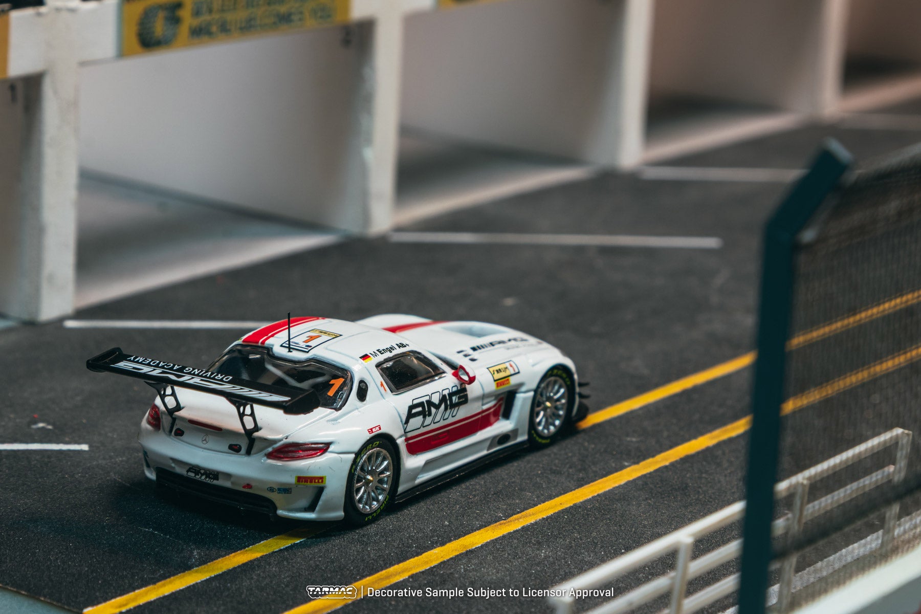 Model race car on a track with visible branding