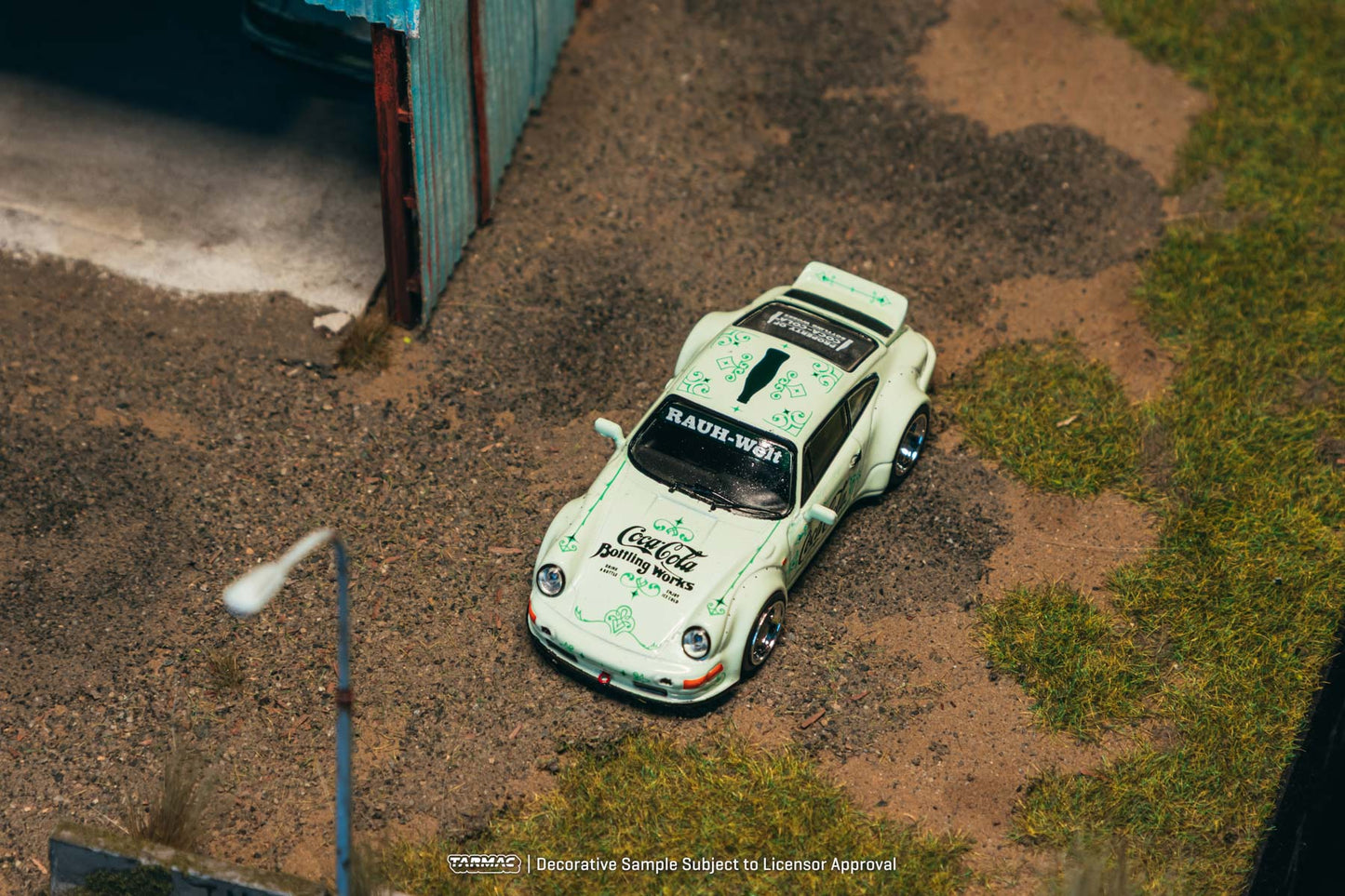 Vintage race car with multiple sponsor logos on a dirt track