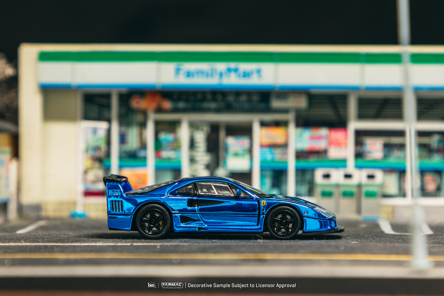 Blue sports car model on a road with a blurred store in the background