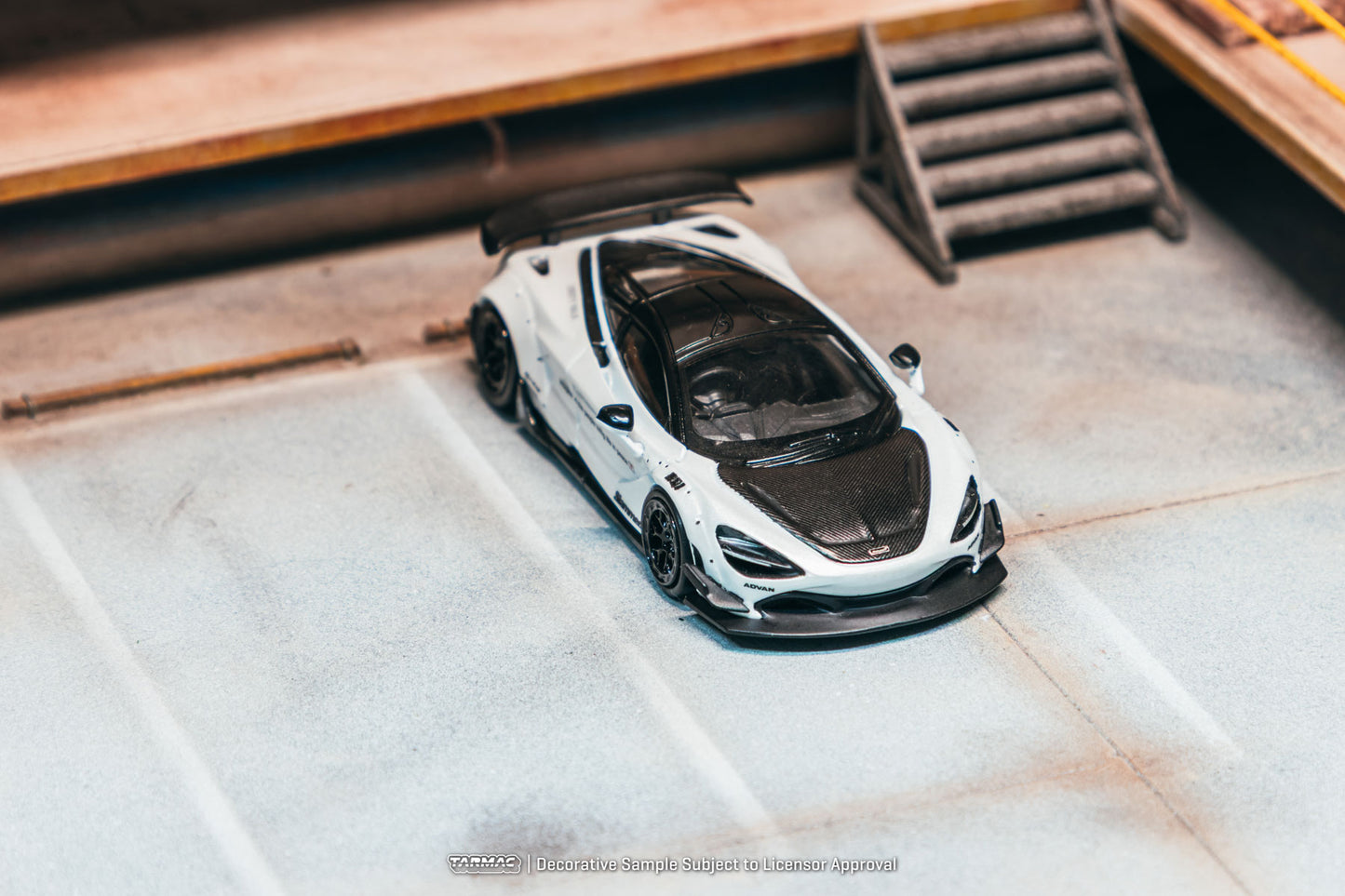 Model of a sports car on a textured surface with wooden background