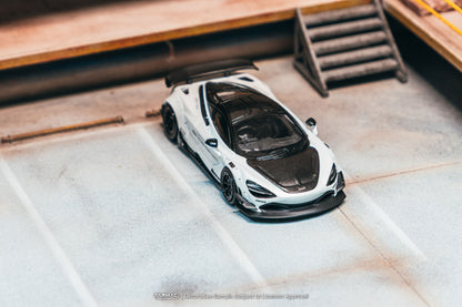 Model of a sports car on a textured surface with wooden background